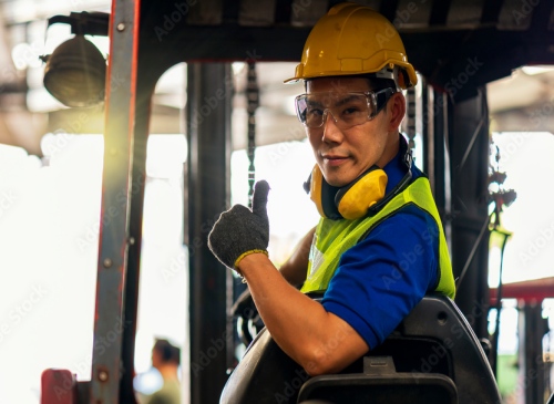 Male Forklift Operator smiling while working