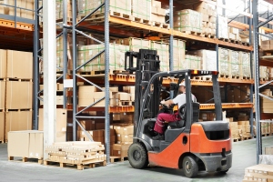 Warehouse Forklift Driver Arranging Boxes in Stack