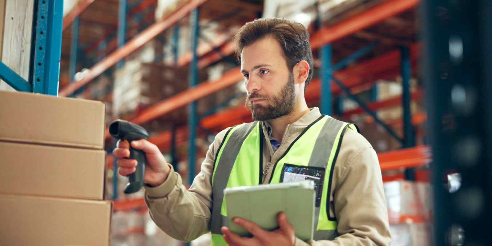Order Selector Scanning A Box in Warehouse